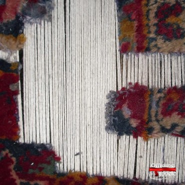 Completamento dell'ordito visto dal dritto di un tappeto Kashan